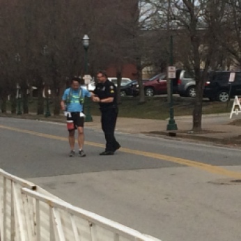 Officer John congratulates a runner